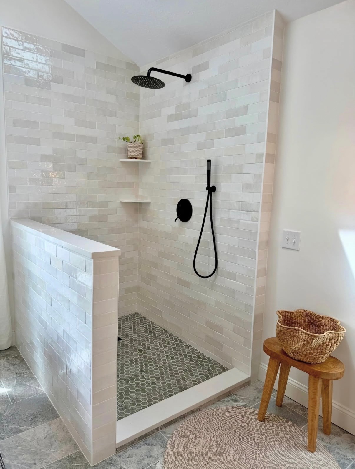 Bright walk-in shower beside freshly finished bathroom walls