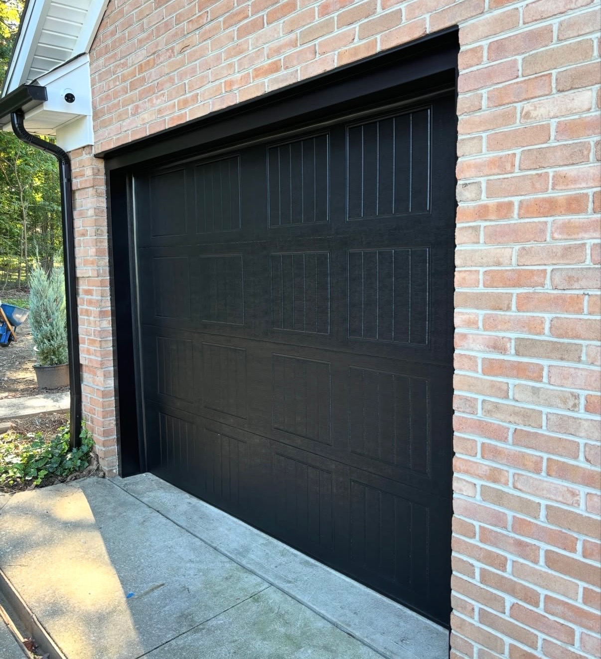 Freshly finished black carriage-style garage door