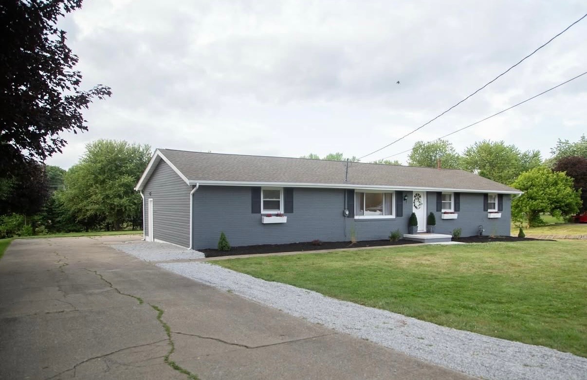 Fresh gray ranch exterior with white trim and dark shutters