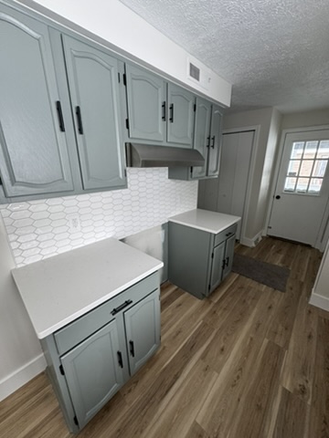 Refinished gray cabinets with black hardware